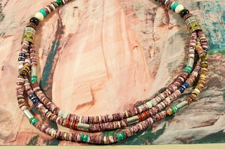 3 Beautiful Strands of Genuine Purple Spiny Oyster Shell with Sterling Silver & Gold Fill Barrels. Sterling Silver Beads & Clasp. Necklace Features Genuine Turquoise, Blue Lapis and Black Onyx Accents. Created by Navajo Artist Tommy Singer. Signed.